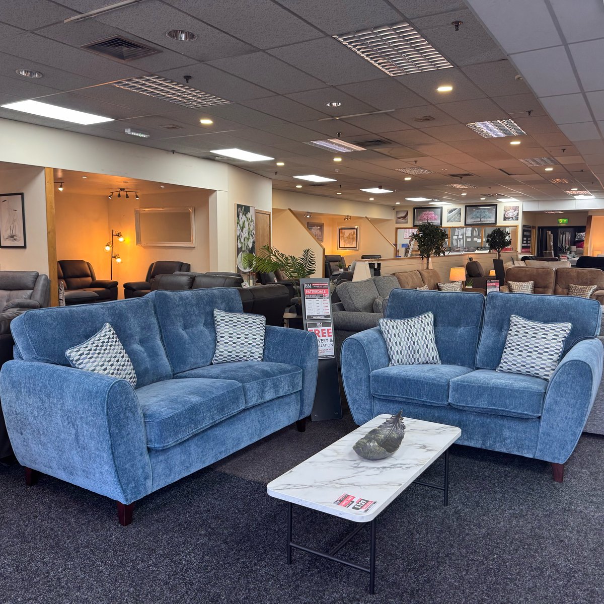 Blue fabric sofas on display at the BM Furniture Blackpool showroom