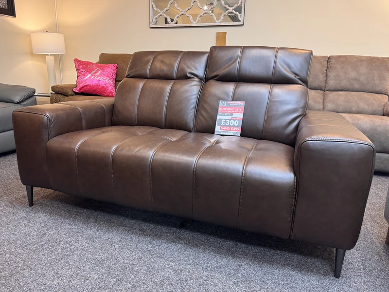 Brown leather 2 seater sofa with stitched panel seats and dark legs, with its clearance ticket, in our Blackpool showroom