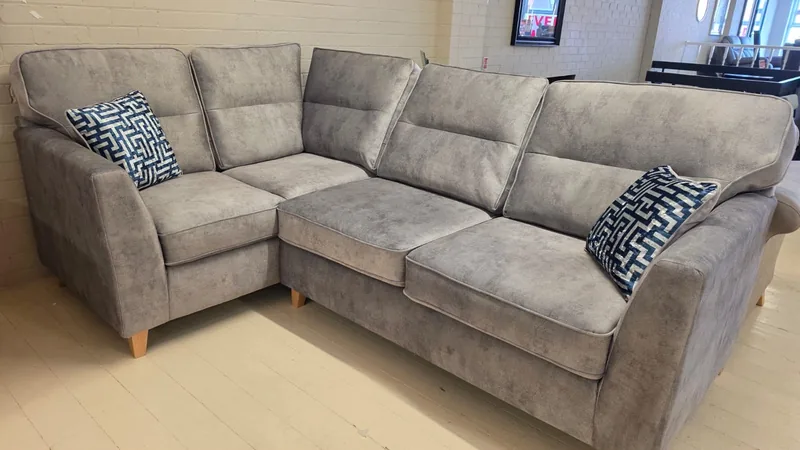 Light grey fabric corner sofa with geometric scatter cushions, in our Cleveleys showroom